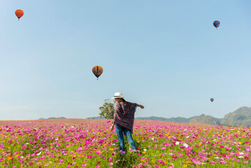 lifestyle traveler women raise hand feeling good relax and happy freedom and see the fire balloon ou