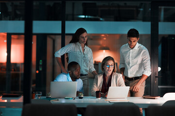 Fototapete - Partnership, laptop and business people in office at night with stock market charts for corporate investment. Discussion, computer and financial advisors work on company profit report with deadline.