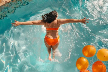 Canvas Print - A plus size woman wearing an orange and blue swimsuit jumps into a swimming pool