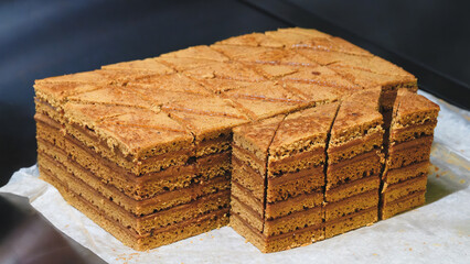 Poster - A stack of brownies with a few slices missing. Concept of indulgence and temptation, as the brownies are piled high and appear to be delicious