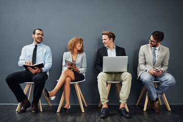 Poster - Corporate people, recruitment and waiting room in conversation or networking for job search opportunity. Group of business candidate talk in queue, chair and online technology by gray wall background