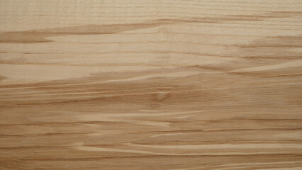 Poster - A wooden surface with a grainy texture background. The wood appears to be aged and has a natural, rustic feel to it. The grain of the wood is visible in the image