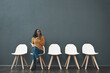 © DoneDeal/peopleimages.com - Waiting, tired and woman for recruitment, hiring and meeting for interview in office. Chairs, yawning and female person as candidate of human resources, exhausted and yawn with document in workplace
