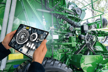 Poster - Serviceman with digital tablet next to combine harvester with open hood.