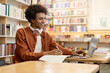 © Home-stock - Happy Black student guy prepare assignment, learning theory, using laptop while studying in college library, using modern wireless tech and internet resources