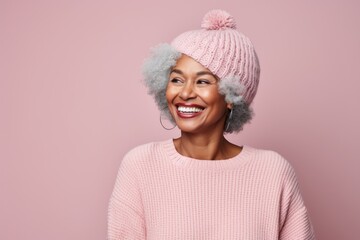 Sticker - Portrait of a satisfied afro-american woman in her 60s donning a warm wool beanie on pastel or soft colors background