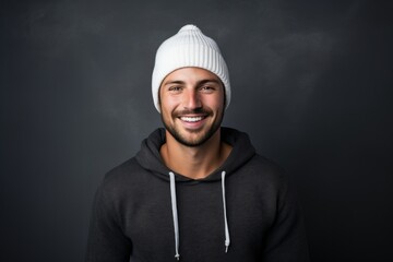 Poster - Portrait of a grinning man in his 30s donning a warm wool beanie while standing against minimalist or empty room background