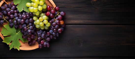 Aufkleber - top view of various types of grapes on vintage plate on black wooden surface. Creative banner. Copyspace image