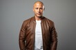 © CogniLens - Portrait of a glad man in his 40s wearing a trendy bomber jacket while standing against minimalist or empty room background