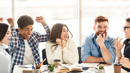 Aufkleber - A diverse group of students are seated around a conference table, engaged in laughter and animated conversation. They appear to be enjoying a moment of camaraderie and shared humor