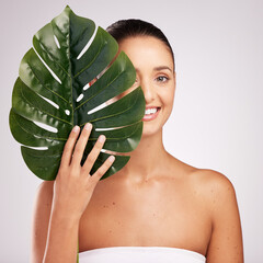 Poster - Woman, leaf and vegan beauty in studio, smooth skin and sustainable skincare on white background. Female person, monstera plant and organic facial treatment, dermatology and eco friendly cosmetics