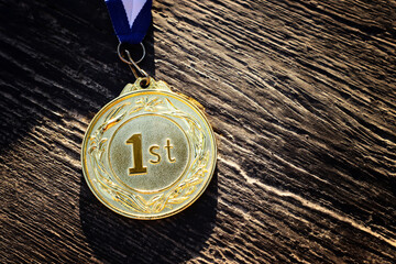 Wall Mural - image of gold medal over wooden table. award and victory concept