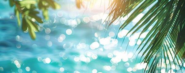 Wall Mural - Sunny tropical scene with palm tree leaves against blurry ocean background