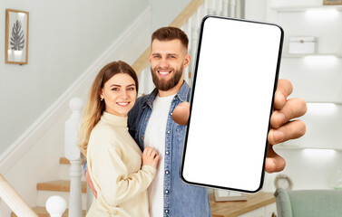 Poster - A man and a woman standing together, holding up a cell phone in their hands.