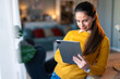 © Dorde - Smiling woman entrepreneur working from home over digital tablet.