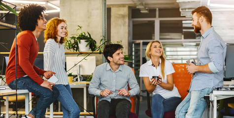 Poster - A group of individuals are seated in a circular formation, facing each other. They appear engaged in conversation or a discussion, with some gesturing or listening intently, sharing business ideas