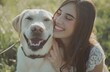 © MD - Young Woman Smiling and Petting Labrador Retriever in Park