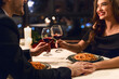 © Prostock-studio - Happy couple having romantic dinner in restaurant, eating pasta and drinking red wine. Happy Valentine day concept
