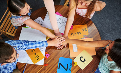 Fototapete - Children, teacher and stack hands in class for support, teamwork and collaboration for education goals. Kids, circle or scrum with diversity, above and learning with development, progress and math