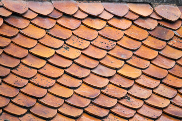 Wall Mural - The roof is made of brown tiles and has a pattern of triangles