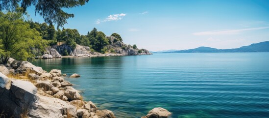 Aufkleber - View of the blue lake from the rocky shore. Creative banner. Copyspace image
