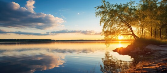 Wall Mural - sunset at coast of the lake Nature landscape Nature in northern Europe reflection blue sky and yellow sunlight landscape during sunset. Creative banner. Copyspace image