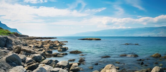 Poster - view of rocky beach with wide sky and flowing water. Creative banner. Copyspace image