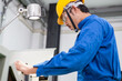 © winnievinzence - experienced operator technician worker or engineer metalworker industrial in safety helmet working or repair on metal machine, professional maintenance skill man in industry manufacturing. men at work
