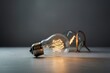 © Jureeporn - A vintage-style glowing filament light bulb resting on a table, symbolizing creativity, innovation, and new ideas.
