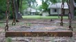 © Parintron - Close-up of a vintage metal swing set, showing signs of wear but still standing strong in a community park.