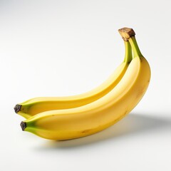 Two ripe yellow bananas with green tips on a white background. Perfect for healthy eating, snacks, or smoothie ingredients.