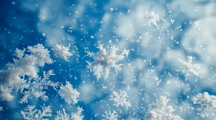 Poster - mesmerizing white snowflakes swirling and dancing in the air against a backdrop of vibrant blue sky, conveying the beauty of winter's magic.