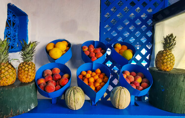 Various exotic fruits are displayed on a blue background.