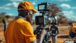 © Denisa - African male film director oversees filming of blockbuster scenes
