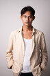 © wdnld - Young man in beige shirt with neutral expression