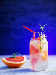 Wall Mural - refreshing chilled summer lemonade with grapefruit slices. decorated with a sprig of rosemary