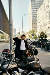 Wall Mural - A stylish young man with red hair standing by a row of parked motorcycles in the city.