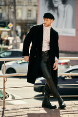 Wall Mural - A young man in debonair black coat and hat walking down city street.