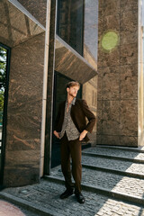 Wall Mural - Red-haired young man in debonair suit walking up city steps.