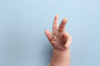 © Svetlana - hand of a newborn baby. hand on a blue background. baby hands