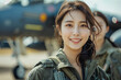 © S photographer - Asian female Air Force pilot looking at camera in fighter jet parking lot.