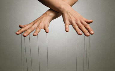 Wall Mural - A puppeteer's hands with strings on each finger.