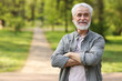 © New Africa - Portrait of happy grandpa with grey hair in park, space for text