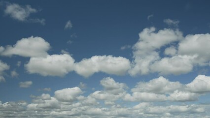 Wall Mural - time lapse video, slow movement of white clouds in sky on a sunny spring day.