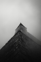 Poster - A tall building with a steeple and a grey sky