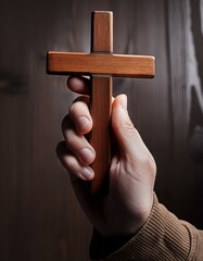 Wall Mural - Wooden Christian Cross being held by Dark Skinned Hand - Symbol of Christianity - Believe and Faith in Christ or God - Praying or Wishing - Worshipping of Religion - Asking for Blessing from Above