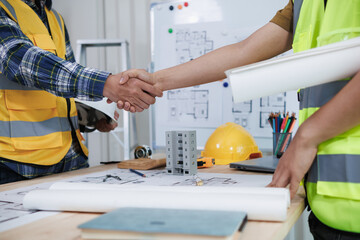 Wall Mural - group of businessmen and investors join hands to symbolize cooperation in investing in real estate business together. concept of touching hands touching hands together to show cooperation and promise.