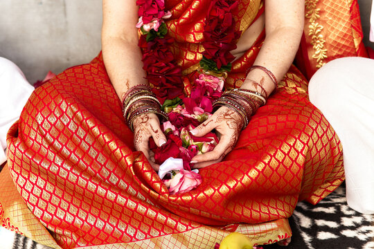 Hands of an indian bride with henna tattoos during an Indian traditional wedding ceremony