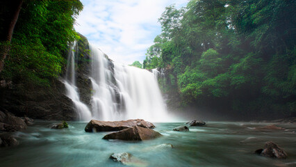 Wall Mural - Beauty in nature, amazing waterfall in tropical forest of national park, Thailand