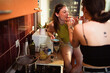 © Marko Geber - Lesbian couple sharing a moment in the kitchen while cooking dinner together